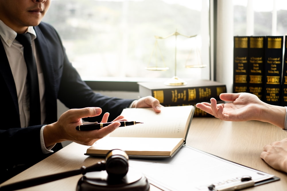 Lawyer signs documents with his client